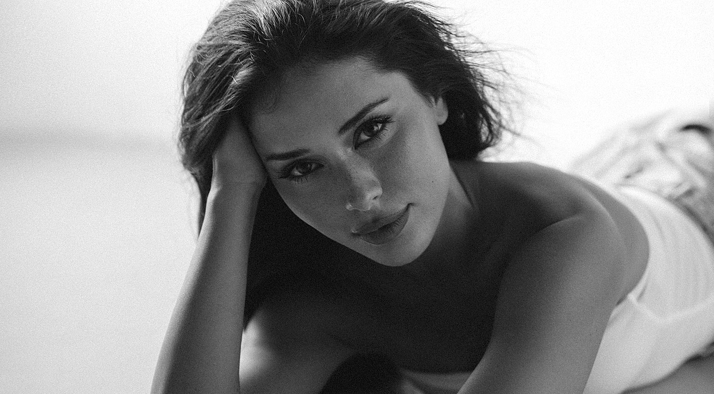 Black and white portrait of a woman posing.