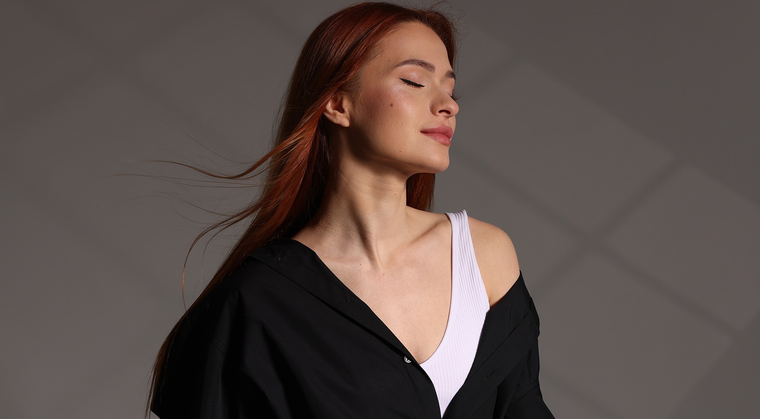 Woman with red hair in studio lighting.
